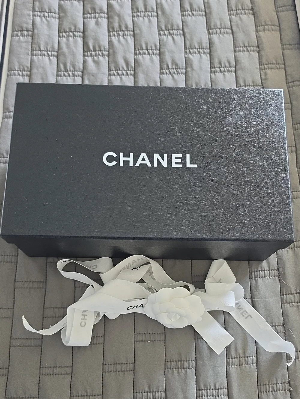 CHANEL Black Box with White Ribbon and Camellia Accent